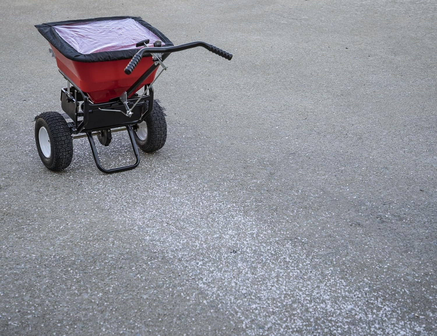 Multi-purpose push-along spreader, 100 lb capacity, versatile tool for lawn seed, salt, de-icer, fertilizer and seeds